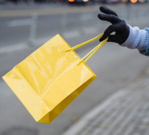 yellow bag held by gloved hand