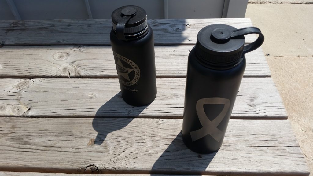 Hydro flask and bottle sitting in the sun
