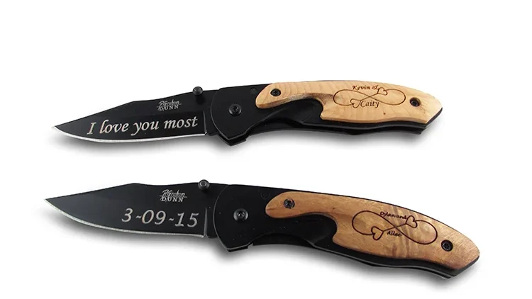 Two black blade wood inlay knives with laser engraving on blade and handle on white background