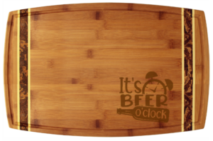 laser engraved cutting board with text "It's beer o' clock" in lower right corner
