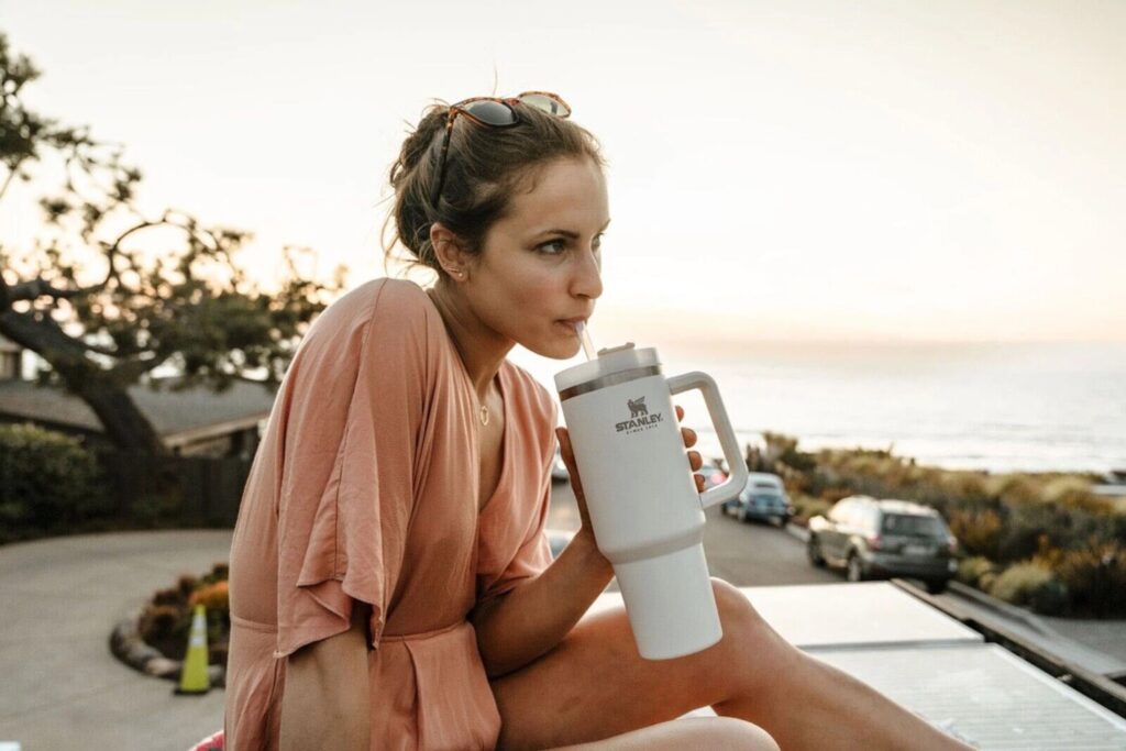 Girl drinking Stanley 40 oz tumbler near road