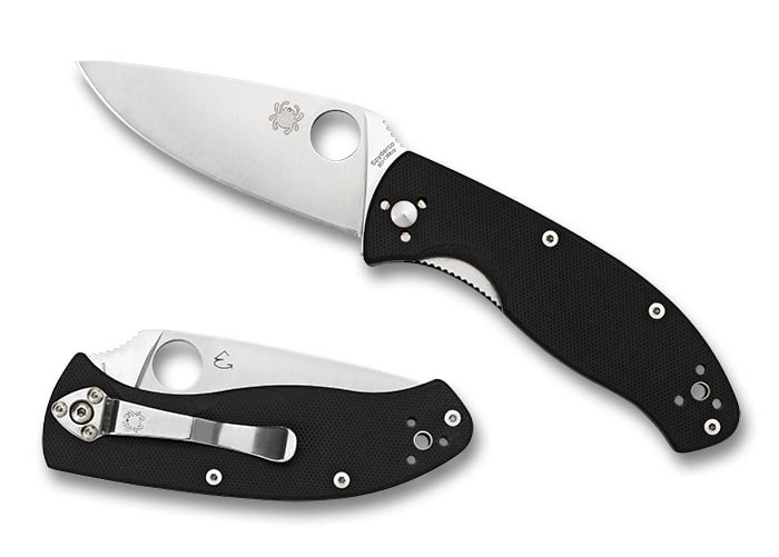 Two Spyderco pocket knives one open one closed, with laser engraved blades on white background
