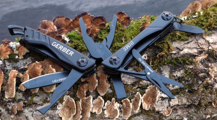 Gerber Dime opened to show tools while sitting on a log