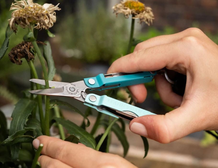 leatherman micra teal tool showing scissors pruning a flower
