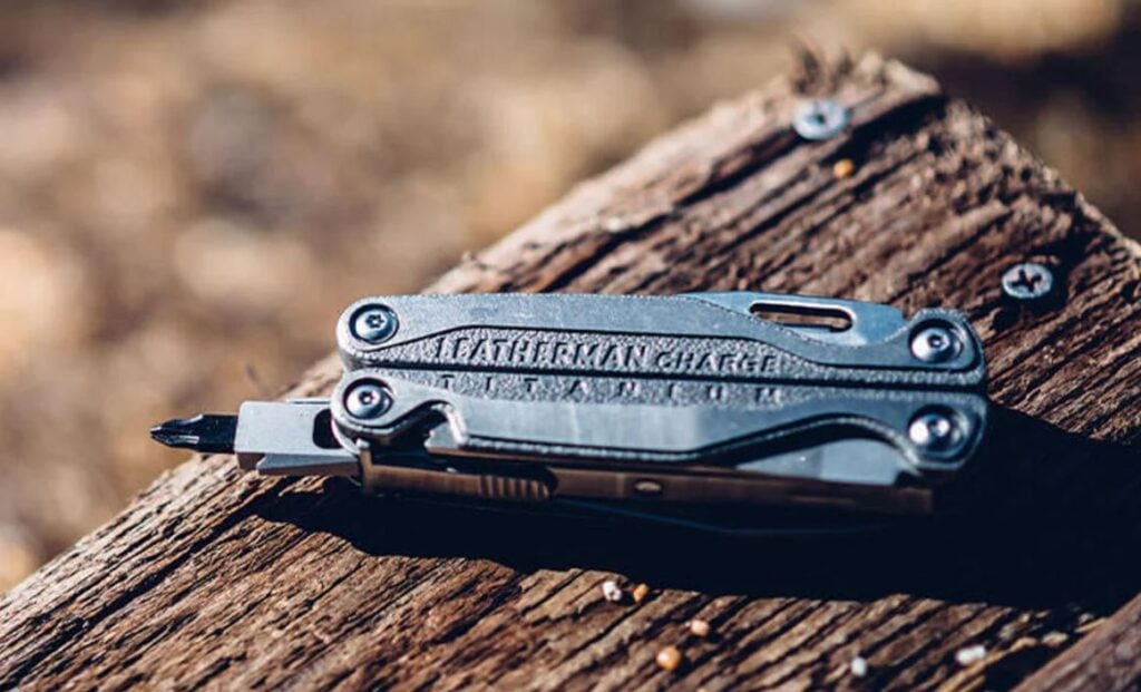 Leatherman charge plus with bit out on wood surface