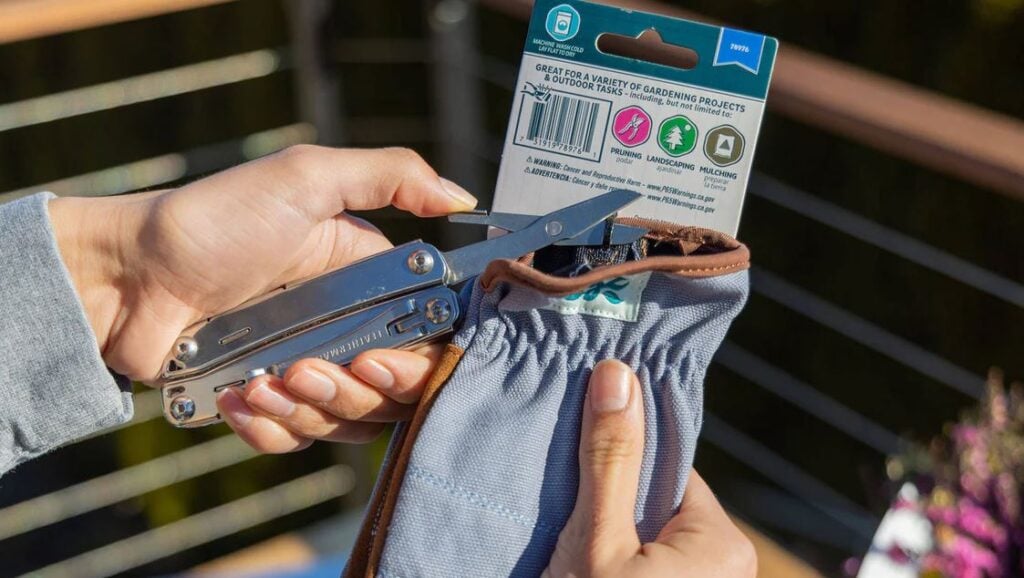 Leatherman Wingman in use clipping plastic tie packaging for garden gloves