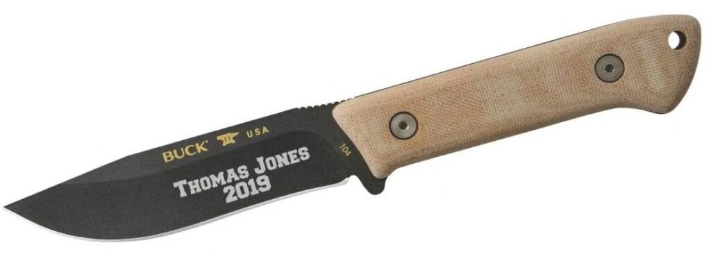 laser engraved buck pocket knife with black blade and tan handle on white background