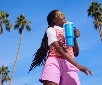 Woman holding blue Stanley quencher