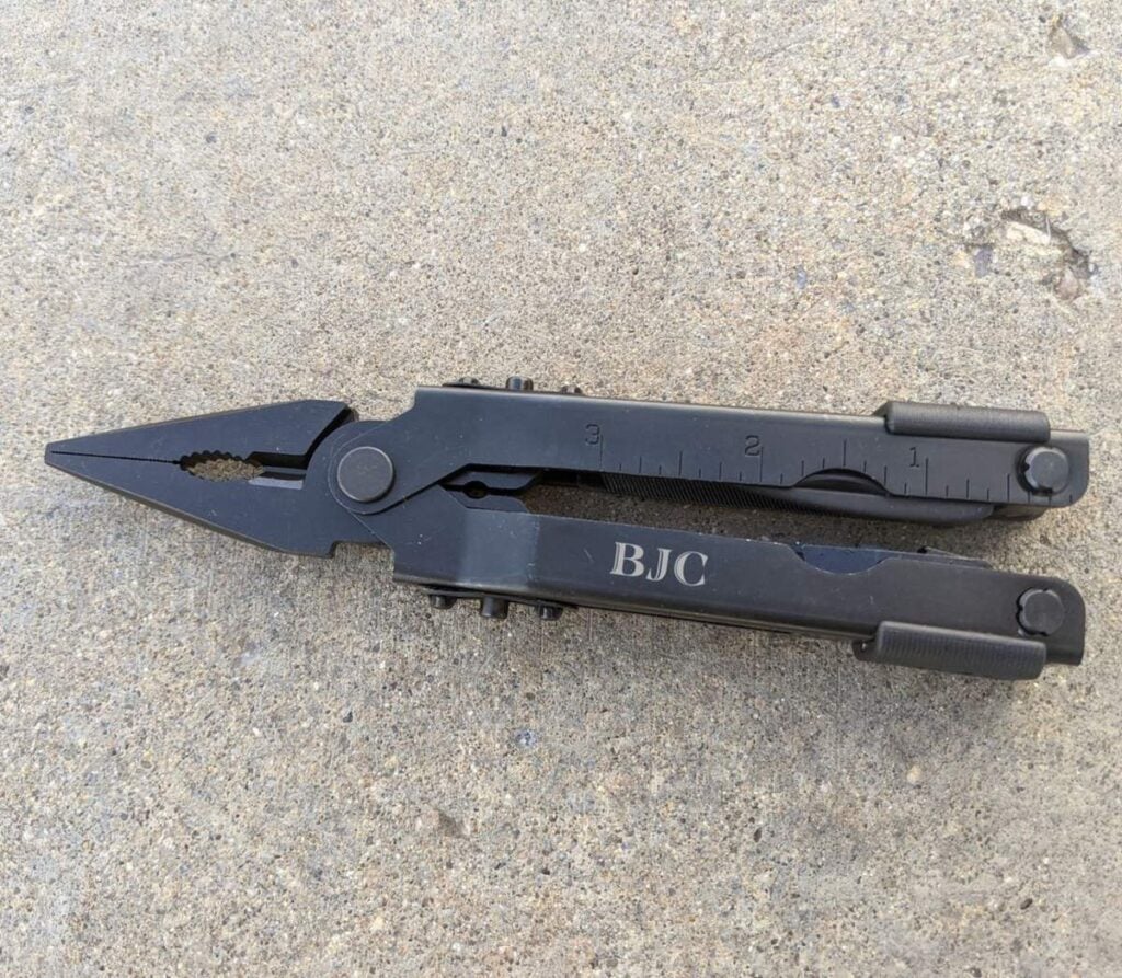 Engraved Gerber MP600 multitool on concrete